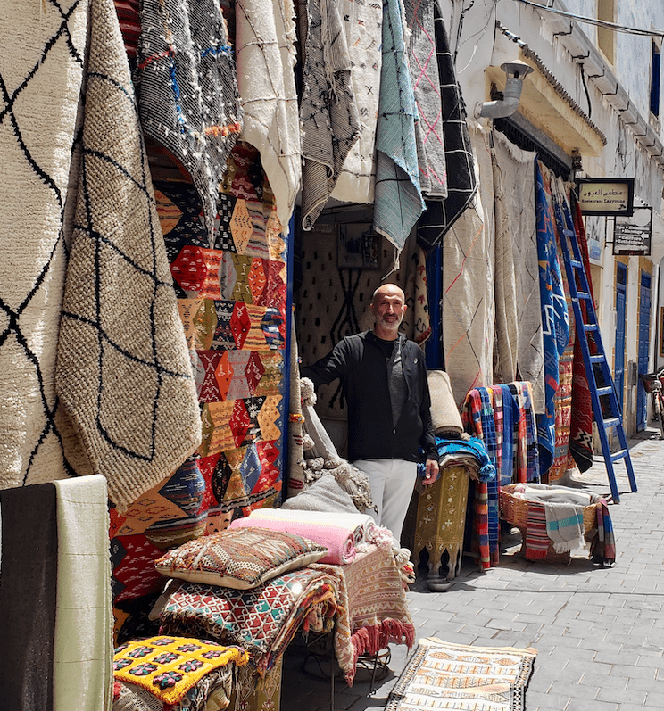 James Royce founder James Mohaber with rugs in Morocco